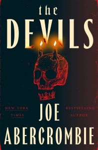 An image of the book cover of The Devils by Joe Abercrombie. The background is black, with a red drawn skull in the center. The skull's jawbone is a crown, and it has two lit candles on top, like horns. The text, from top to bottom, reads, "the DEVILS / NEW YORK TIMES BESTSELLING AUTHOR / JOE ABERCROMBIE".